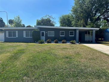 Charming single-story home with well-maintained lawn and covered carport at 312 Verbena Dr, Orlando, FL 32807