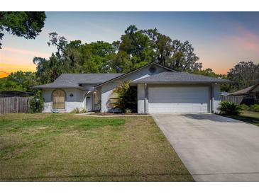 Charming single-story home with well-maintained lawn and attached two-car garage at 515 Columbus Ave, Orange City, FL 32763