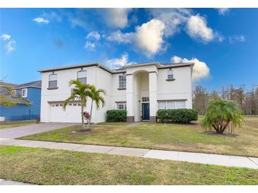 Well-maintained two-story home featuring a manicured lawn and a classic architectural design at 5502 Willow Bend Trl, Kissimmee, FL 34758