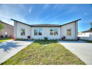 Beautiful single-Gathering home featuring a modern design, manicured lawn, and freshly poured driveway at 804 Colville Dr, Kissimmee, FL 34759
