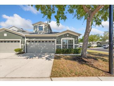 Charming one-story home with gray exterior, landscaped front yard, and two-car garage at 819 Featherstone Ln, Lake Mary, FL 32746