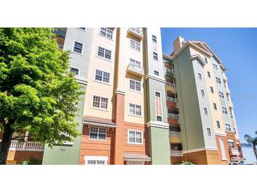Colorful building exterior featuring balconies and a well-maintained facade at 8743 S The Esplanade # 18, Orlando, FL 32836