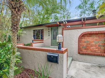 Close up of the home's entry with brick accents, updated hardware, and mailbox at 410 Sandspur N Rd, Maitland, FL 32751