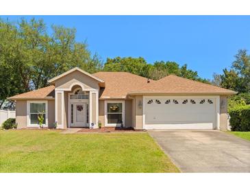 Charming single-story home with a well-manicured lawn and a welcoming front entrance at 1330 Broken Pine Rd, Deltona, FL 32725