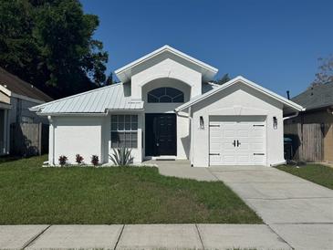 Charming single-story home with a well-manicured lawn and a freshly painted, modern exterior at 1538 Brookebridge Dr, Orlando, FL 32825