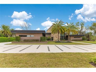 Stunning home showcasing a contemporary design, lush landscaping, and a decorative driveway at 1766 Alaqua Dr, Longwood, FL 32779