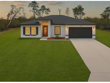 Inviting single-story home with a well-manicured lawn and a modern front facade at 2232 Sw 178Th Lane Rd, Ocala, FL 34473