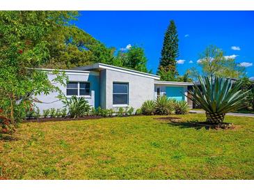 Charming home featuring a well-maintained lawn and a striking agave plant at 2501 Weber St, Orlando, FL 32803