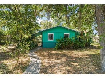 Charming single-story home features lush landscaping and a welcoming walkway at 290 Pine St, Ormond Beach, FL 32174
