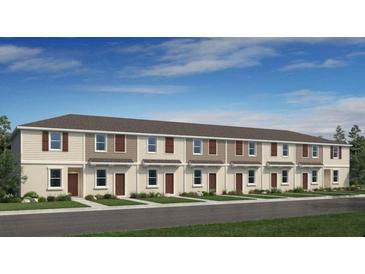 Attractive two-story townhomes with neutral colors and well-manicured lawns, located on a paved street at 3133 Skyline Loop, Kissimmee, FL 34758