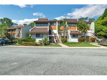 Inviting exterior view of the multi-Gathering property, enhanced by lush landscaping and mature trees at 4616 Tower Pine Rd # 4616, Orlando, FL 32839