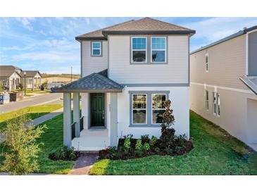 Charming two-story home with a welcoming porch and well-manicured landscaping at 4827 Lacewing Dr, Winter Garden, FL 34787