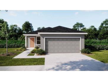 Charming single-story home with a two-car garage, manicured lawn, and inviting curb appeal at 5535 Maddie Dr, Haines City, FL 33844