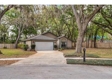 Charming single-story home featuring a well-maintained lawn, driveway, and two-car garage at 1210 Baypoint Ct, Longwood, FL 32750