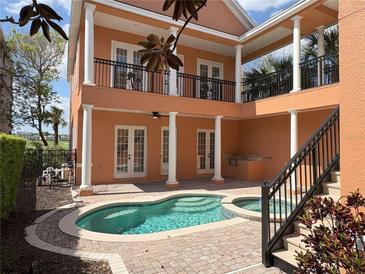 Lovely courtyard pool area with upstairs balcony overlooking the pool at 1554 Corolla Ct, Reunion, FL 34747