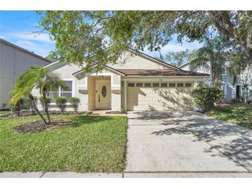 Charming single-story home featuring a well-manicured lawn and a two-car garage at 300 Augustine Ct, Oviedo, FL 32765