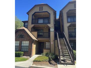 Condo building featuring a balcony and staircase leading to upper-level units at 315 Lakepointe Dr # 201, Altamonte Springs, FL 32701