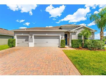 Charming single-story home featuring a three-car garage, brick driveway and well-manicured landscaping at 3632 Gretchen Dr, Ocoee, FL 34761