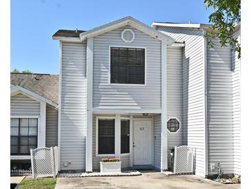 Inviting two-story home with a well-maintained yard and classic architectural details on a sunny day at 615 Clemson Dr, Altamonte Springs, FL 32714