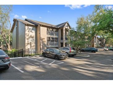 Apartment complex with parking, featuring balconies and a well-maintained exterior, set against a blue sky at 623 Dory Ln # 307, Altamonte Springs, FL 32714