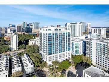 Stunning aerial view of a modern high-rise building in a bustling city with blue skies and mature landscaping at 260 Osceola Ave # 902, Orlando, FL 32801