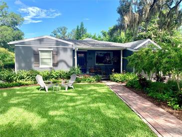 Charming single-story home with a well-manicured lawn, beautiful landscaping and cozy sitting area at 750 Hempstead Ave, Orlando, FL 32803