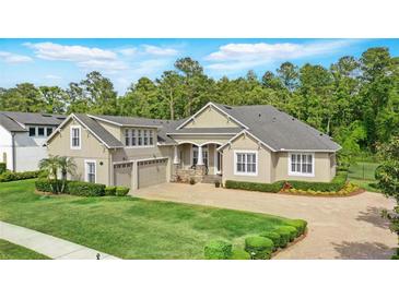 Beautiful single Gathering home featuring a well-manicured lawn and a circular driveway at 452 Raccoon St, Lake Mary, FL 32746