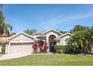 Charming single-Gathering home with a well-manicured lawn and colorful landscaping at 14021 King Sago Ct, Orlando, FL 32828