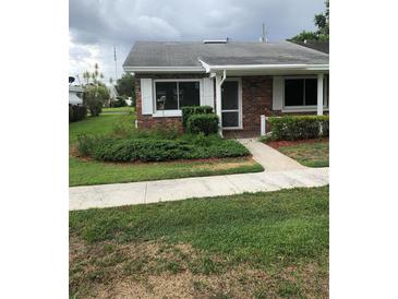 Charming brick home with a well-manicured lawn and landscaping at 769 Avenue Q Se, Winter Haven, FL 33880