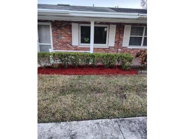Charming brick home featuring well-maintained landscaping and large windows at 769 Avenue Q Se, Winter Haven, FL 33880