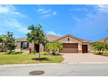 Charming single-story home showcasing a manicured lawn, large driveway, and well-maintained landscaping at 611 San Raphael St, Kissimmee, FL 34759