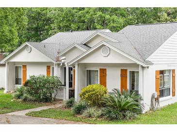 Charming single-story home with wooden shutters and lush landscaping at 407 Forest Rd, Mount Dora, FL 32757