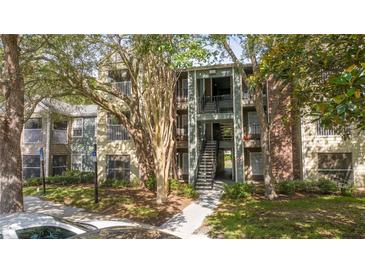Inviting condo complex with lush landscaping and charming architectural details at 5136 Park Central Dr # 212, Orlando, FL 32829