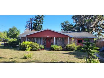 Charming single-story brick home with covered entry and mature landscaping at 1066 Geneva Dr, Oviedo, FL 32765