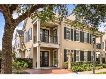 Charming two-story townhome featuring black shutters, a balcony, and well-maintained landscaping at 1316 Lake Baldwin Ln, Orlando, FL 32814