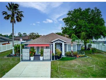 Charming single-story home with mature landscaping, decorative screens, and a covered front entrance at 1448 Lambert St, Deltona, FL 32725