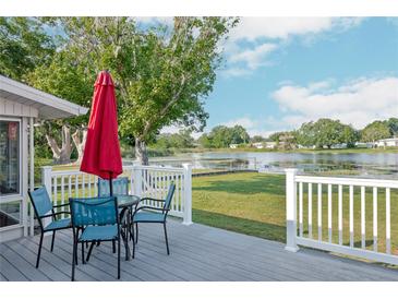 Inviting back deck with seating area overlooking serene lake views, perfect for relaxing outdoors at 3 Poinsettia Dr, Debary, FL 32713