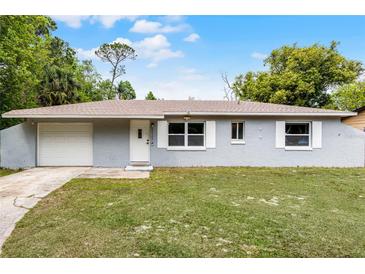 Charming single-story home with a well-maintained lawn, a one-car garage, and a freshly painted exterior at 10105 Crozier Ct, Orlando, FL 32817