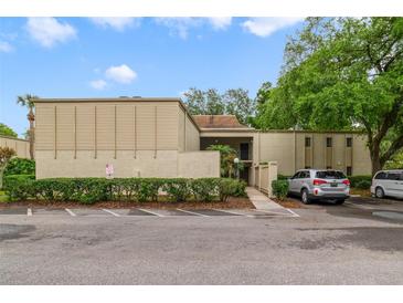 Inviting home featuring a well-maintained exterior with ample parking, and lush landscaping in a suburban setting at 3294 S Semoran Blvd # 14, Orlando, FL 32822