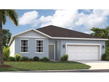 Charming single-story home featuring a well-maintained lawn and a two-car garage at 5925 Cliffbow Loop, Leesburg, FL 34748