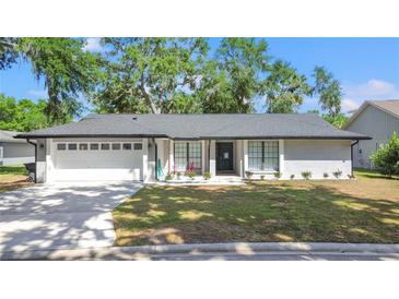 Charming single-story home featuring a manicured lawn and a two-car garage at 6402 Beechnut Dr, Lakeland, FL 33813