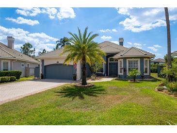 Charming single-Gathering home boasts a well-manicured lawn and lovely landscaping, including a palm tree at 10662 Woodchase Cir, Orlando, FL 32836