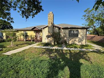 Charming single-Gathering home with a stone exterior and a lovely stone chimney at 1221 Perkins Rd, Orlando, FL 32809