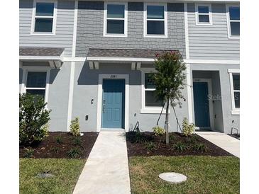 New construction townhome features light blue siding and a small front yard with new landscaping at 2081 Viewfinder St, Kissimmee, FL 34758