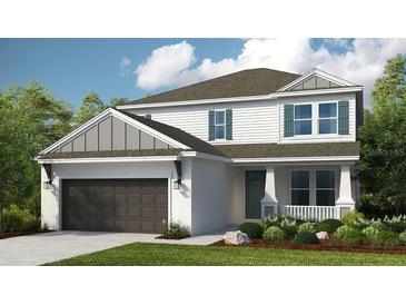 Charming two-story home showcases neutral paint, green shutters, manicured lawn, and inviting two-car garage at 5241 Quillback Ln, St Cloud, FL 34771