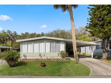Charming single-story home with well-maintained landscaping, covered parking, and a welcoming facade at 8 Cocos Plumosa Dr # A, Eustis, FL 32726