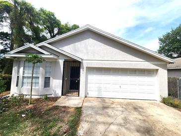 Close-up of a charming single-story home showcasing its well-kept exterior and inviting entrance, complete with a security gate at 101 Dovetail Ct, Apopka, FL 32703