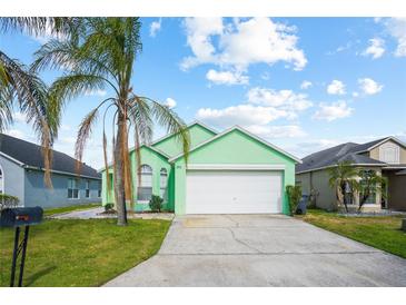 Charming, mint-green single-Gathering home with a well-maintained lawn and a two-car garage at 202 Aylesbury Ln, Davenport, FL 33837