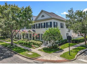 Charming two-story home with manicured landscaping, lush trees, and classic architectural details at 2240 Osprey Ave, Orlando, FL 32814