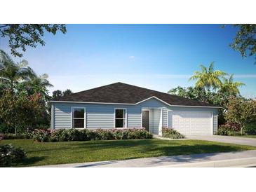 Charming single-story home featuring a two-car garage, well-manicured lawn and tidy landscaping at 114 Tulip Ln, Poinciana, FL 34759